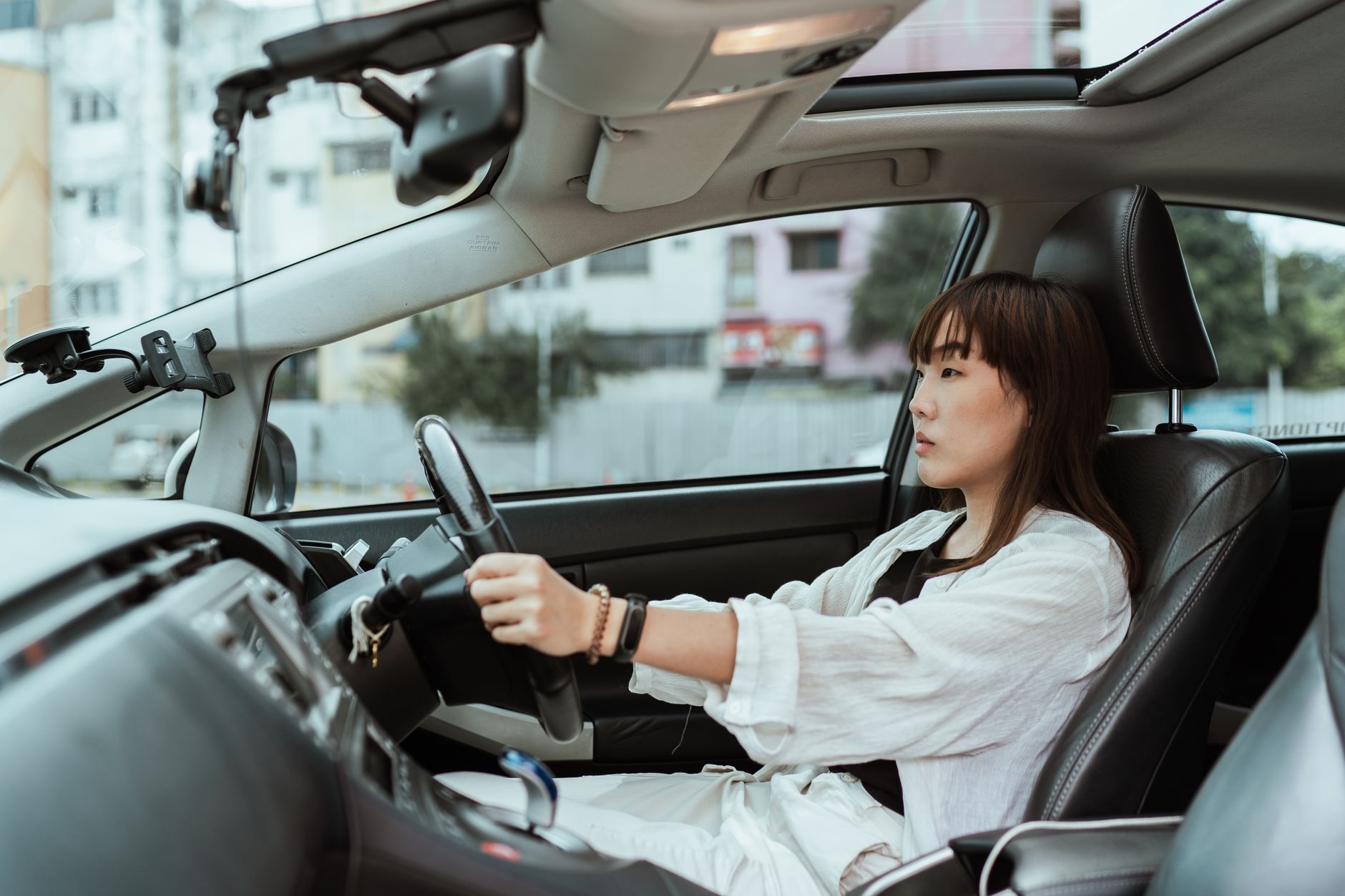 Jeune conductrice au volant en ville