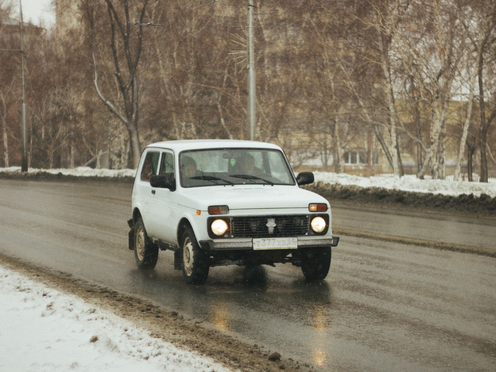 SUV blanc sur route enneigée en hiver